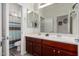 Bathroom with a double vanity, wood floors, and a shower-tub combination at 15062 W Windward Ave, Goodyear, AZ 85395
