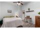 Bedroom featuring wood floors, a ceiling fan, and neutral paint at 15062 W Windward Ave, Goodyear, AZ 85395