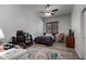 Bedroom features a ceiling fan, wood-look floors, and neutral color palette at 15062 W Windward Ave, Goodyear, AZ 85395