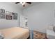 Bright bedroom featuring an ensuite bathroom, ceiling fan, and wood-look floors at 15062 W Windward Ave, Goodyear, AZ 85395