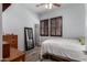 Bedroom with wood floors, a ceiling fan, and plantation shutters at 15062 W Windward Ave, Goodyear, AZ 85395