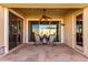 Covered patio with ceiling fan offers shade and access to the well maintained yard at 15062 W Windward Ave, Goodyear, AZ 85395