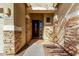 Covered front porch featuring stone accents and a decorative front door at 15062 W Windward Ave, Goodyear, AZ 85395