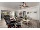 Comfortable living room with a ceiling fan and neutral decor, perfect for relaxing and entertaining guests at 15062 W Windward Ave, Goodyear, AZ 85395