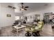 Open living area featuring wood-look tile floors, neutral colors, and comfortable seating at 15062 W Windward Ave, Goodyear, AZ 85395