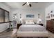 Comfortable main bedroom with wood-look floors, ceiling fan, and outdoor access at 15062 W Windward Ave, Goodyear, AZ 85395