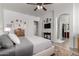 Bright main bedroom features ensuite bathroom, ceiling fan, and neutral color palette at 15062 W Windward Ave, Goodyear, AZ 85395
