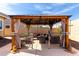Outdoor seating with an elegant, covered gazebo provides shade and a comfortable gathering space at 15062 W Windward Ave, Goodyear, AZ 85395