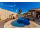 Backyard pool offers an elegant rock waterfall feature and outdoor bar area at 15062 W Windward Ave, Goodyear, AZ 85395