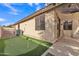 Backyard putting green leads to an extended, covered patio with rocking chairs at 16847 W Marconi Ave, Surprise, AZ 85388