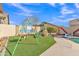 The backyard includes a swing set and play area on artificial turf at 16847 W Marconi Ave, Surprise, AZ 85388