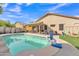 The backyard oasis with a sparkling pool, covered patio, and a play area, making it an ideal space for Gathering entertainment at 16847 W Marconi Ave, Surprise, AZ 85388