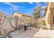 A cozy backyard patio with a dining set and rocking chairs provides an ideal spot for relaxation and outdoor gatherings at 16847 W Marconi Ave, Surprise, AZ 85388