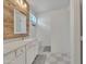 Bathroom featuring a double vanity, decorative wood wall, modern lighting, and a walk-in shower at 16847 W Marconi Ave, Surprise, AZ 85388