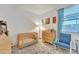 Cozy Bedroom with crib, dresser, and chair, perfect for a new baby at 16847 W Marconi Ave, Surprise, AZ 85388