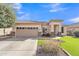 Inviting single-story home with well-maintained front yard and stone accents at 16847 W Marconi Ave, Surprise, AZ 85388
