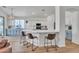Open-concept kitchen with stainless steel appliances, breakfast bar, and stylish pendant lighting at 16847 W Marconi Ave, Surprise, AZ 85388