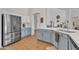 Bright kitchen features stainless steel appliances, tiled floors, and updated counter tops at 16847 W Marconi Ave, Surprise, AZ 85388