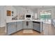 This open floorplan features a spacious kitchen with stainless appliances, granite countertops, and backyard views at 16847 W Marconi Ave, Surprise, AZ 85388