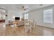 Open living room features wood-look flooring, modern furnishings, and plenty of natural light at 16847 W Marconi Ave, Surprise, AZ 85388