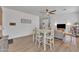 Bright living area with wood-look floors, a dining table set, and cozy decor at 16847 W Marconi Ave, Surprise, AZ 85388