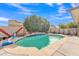 The pool features a waterfall feature and a basketball hoop, perfect for summer fun at 16847 W Marconi Ave, Surprise, AZ 85388