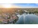 Expansive aerial view showcasing the community's many homes, lakes, mature trees, and neighborhood pool at 1700 E Lakeside Dr # 16, Gilbert, AZ 85234