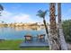 Outdoor patio area with lake views and two chairs near palm trees at 1700 E Lakeside Dr # 16, Gilbert, AZ 85234