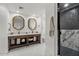 Bright bathroom with dual vanities, elegant mirrors, and a luxurious tiled shower at 1700 E Lakeside Dr # 16, Gilbert, AZ 85234