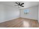 Clean, simple bedroom with hardwood floors, white walls, ceiling fan, and a window at 1700 E Lakeside Dr # 16, Gilbert, AZ 85234