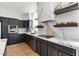 Stylish kitchen showcasing black cabinets, stainless steel appliances, and marble countertops at 1700 E Lakeside Dr # 16, Gilbert, AZ 85234