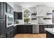 Contemporary kitchen featuring black cabinets, stainless steel appliances, marble backsplash and countertops at 1700 E Lakeside Dr # 16, Gilbert, AZ 85234