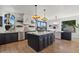 Open kitchen featuring a large island, modern appliances, and a seamless flow to the dining area at 1700 E Lakeside Dr # 16, Gilbert, AZ 85234