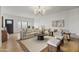 Bright living room features a neutral color palette, hardwood floors, a plush rug, and ample seating at 1700 E Lakeside Dr # 16, Gilbert, AZ 85234