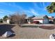 Charming single-story home with a well-maintained front yard and a two-car garage at 17405 N Conquistador Dr, Sun City West, AZ 85375