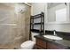 Modern bathroom featuring granite countertops, updated fixtures, and a glass enclosed shower with neutral colored tiles at 17773 N 77Th Way, Scottsdale, AZ 85255