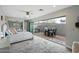 Bright bedroom featuring a ceiling fan, mirrored closet and sliding glass doors to a private patio with outdoor dining area at 17773 N 77Th Way, Scottsdale, AZ 85255