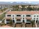 Aerial view of multi-story townhomes featuring red tile roofs, white stucco exteriors, and well-manicured landscaping at 17773 N 77Th Way, Scottsdale, AZ 85255