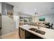 Modern kitchen with sleek countertops and stainless steel appliances seamlessly flowing into the adjacent living area at 17773 N 77Th Way, Scottsdale, AZ 85255