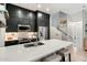 Modern kitchen featuring dark cabinets, stainless steel appliances, and a white countertop with barstool seating at 17773 N 77Th Way, Scottsdale, AZ 85255