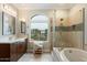 A bright bathroom with a double sink vanity, modern tile flooring, and a large window at 17773 N 77Th Way, Scottsdale, AZ 85255
