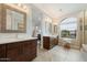 A luxurious bathroom with a double sink vanity, modern tile flooring, and large windows at 17773 N 77Th Way, Scottsdale, AZ 85255