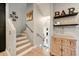 Elegant staircase with wood floors leads to a lower level, showcasing decor and bar accessories at 17773 N 77Th Way, Scottsdale, AZ 85255