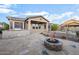 Backyard boasts flagstone patio, built in BBQ, fire pit, and lush desert landscaping at 18391 W Verdin Rd, Goodyear, AZ 85338