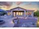 Charming home backyard with desert landscaping, covered patio, and decorative rock at 18391 W Verdin Rd, Goodyear, AZ 85338