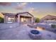 Backyard boasts flagstone patio, built in BBQ, fire pit, and lush desert landscaping at 18391 W Verdin Rd, Goodyear, AZ 85338
