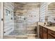 Modern bathroom showcasing a glass shower and decorative stone flooring at 18391 W Verdin Rd, Goodyear, AZ 85338