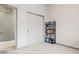 Bedroom with carpet, closet, and a black bookshelf filled with books at 18391 W Verdin Rd, Goodyear, AZ 85338