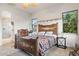 Comfortable bedroom featuring a unique bed frame, natural light, and access to the bathroom at 18391 W Verdin Rd, Goodyear, AZ 85338