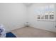 Well-lit bedroom featuring carpet and a window with shutter blinds at 18391 W Verdin Rd, Goodyear, AZ 85338